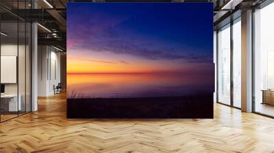 A beautiful spring sunset landscape of a Baltic Sea beach in Riga, Latvia. Colorful evening scenery of Northern Europe. Wall mural