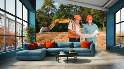 engineer discussing plan with construction worker Wall mural