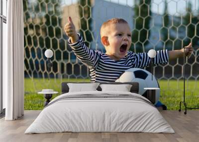 boy with football shouting with glee Wall mural