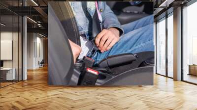 Female Driver Attaching Safety Seat Belt in a Car Wall mural