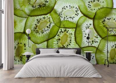 Light through a slice of kiwi isolated on white background. Wall mural