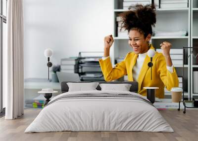 African american businesswoman happy and excited with job accomplished. female employee doing paperwork Accounting at his office Wall mural