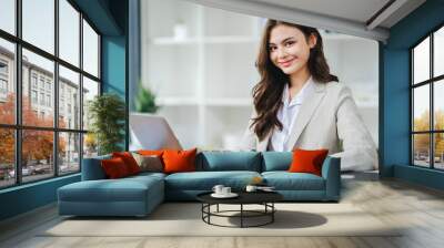 creative business woman using laptop and working in office Wall mural