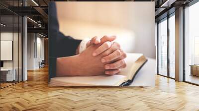 focus on woman's hand While praying for Christianity with blurry body background, casual woman prays with her hands with scriptures. Wall mural