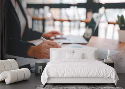 Portrait of a woman working on a tablet computer in a modern office. Make an account analysis report. real estate investment information financial and tax system concepts Wall mural