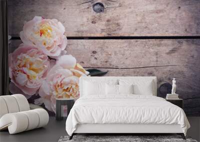 Tender pink peonies flowers on aged wooden background. Flat lay. Wall mural