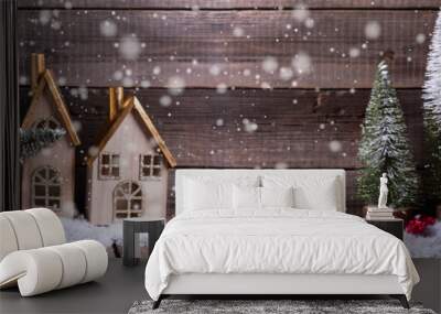 Wrapped boxes in red car, decorative houses and fir trees  on aged wooden background. Wall mural