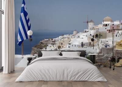 View of windmills with Greece flag in Oia village on island of Santorini, Greece, Europe Wall mural