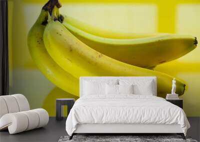 laughing woman eating banana, yellow background Wall mural