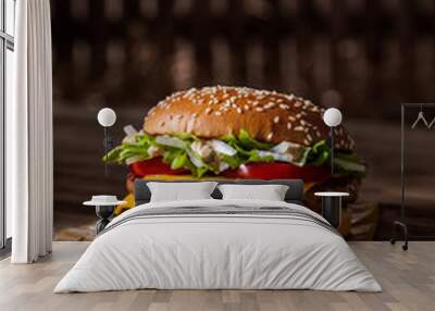 Tasty hamburger on kraft paper on a dark background Wall mural