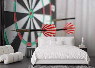 Conceptual photo. Darts on dart board outdoors in summer. Throw darts at the target. The winner, first place. Business target or goal success and winner concept. Wall mural