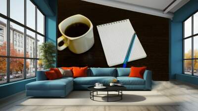 White notepad with a pen on a brown table with a cup of coffee Wall mural