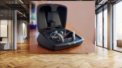 Close Up Of Wireless Hearing Aid Or Device From Charging Case At Home Wall mural