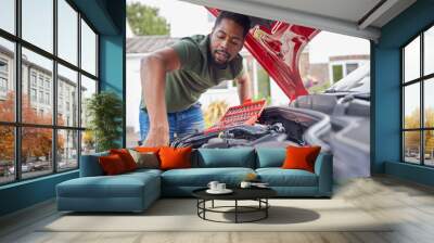 Man Working Under Hood Of Car Fixing Engine With Wrench Wall mural