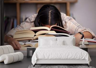 Study books, fatigue and woman student at desk with textbook for test feeling overworked. Stress, female person and home studying for university exam and course with burnout and sleeping in a house Wall mural