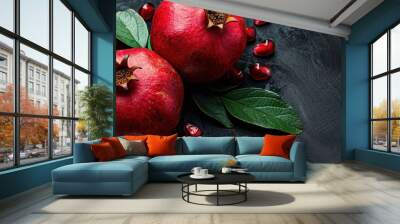 Close-up of a red pomegranate on a dark background, highlighting its rich texture and color. Free copy space for banner. Wall mural