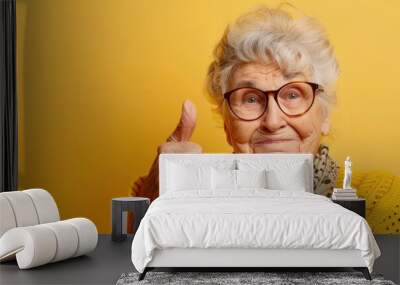 Elderly woman with glasses showing thumbs up. Free copy space for text. Wall mural