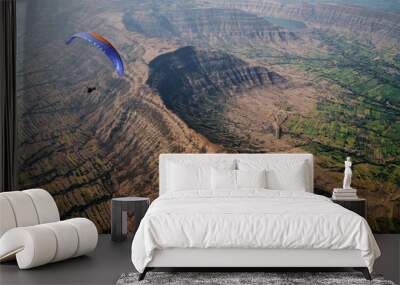 Paragliding pilot over mountains in India Wall mural