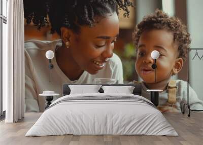 Smiling mother and young son enjoying cookies and milk, sharing a joyful moment together. Wall mural