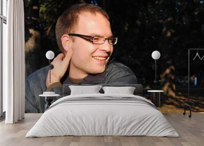 Portrait of a man with eyeglasses smiling Wall mural