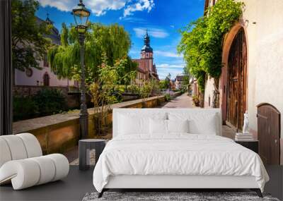 Old city of Ettlingen in Germany with a river and a church. View of a central district of Ettlingen, Germany, with a river and a bell tower of a church. Ettlingen, Baden Wurttemberg, Germany. Wall mural