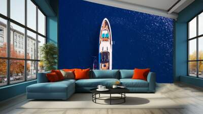 Yacht anchoring in crystal clear turquoise water in front of the tropical island, alternative lifestyle, living on a boat. Aerial view of yacht at anchor on turquoise water, showing luxury, wealth. Wall mural