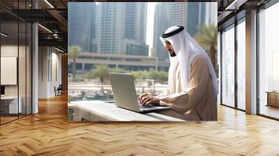 Arab man working with a laptop. Wall mural