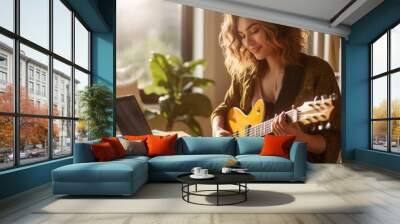 Woman with guitar doing an online music class. Wall mural