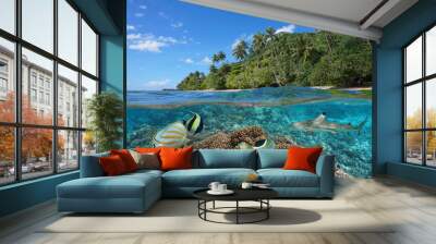 French Polynesia, coral reef with colorful fish underwater and tropical coast with green vegetation, split view over and under water surface, Pacific ocean, Oceania Wall mural