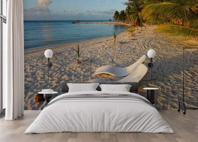 Two sunloungers on sandy tropical beach at dusk, atoll of Tikehau, Tuamotu archipelago, French Polynesia, Pacific ocean
 Wall mural