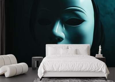 A white theatrical mask with shadowed features is illuminated dramatically against a dark background, focusing on its calm, expressionless face in the shadows. Wall mural