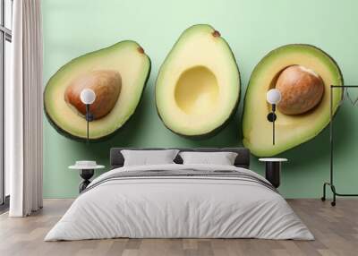 Fresh Avocado Halves on Green Background Wall mural