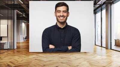 Attractive modern smiling business man in deep blue shirt isolated on gray background Wall mural