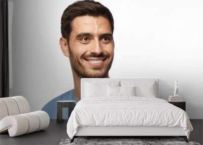 Close up portrait of smiling handsome male in blue t-shirt looking right Wall mural