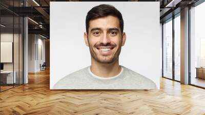 Close-up portrait of smiling handsome man  isolated on gray background Wall mural