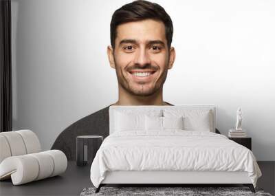 Close-up portrait of smiling handsome young man in casual gray t-shirt Wall mural