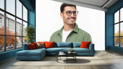 Close-up portrait of young handsome smiling man wearing casual green shirt and glasses, looking away isolated on gray background Wall mural