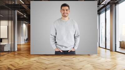 Daylight portrait of young handsome man, wearing oversized sweatshirt Wall mural