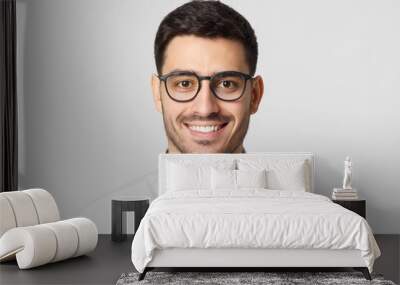 Eyewear fashion. Headshot portrait of handsome smiling man dressed in gray shirt and wearing eyeglasses, isolated on studio background Wall mural