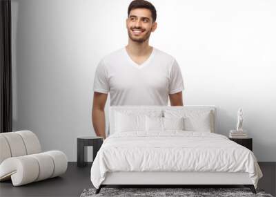 Front mockup of young man standing with hands in pockets, wearing blank white t-shirt with copy space Wall mural