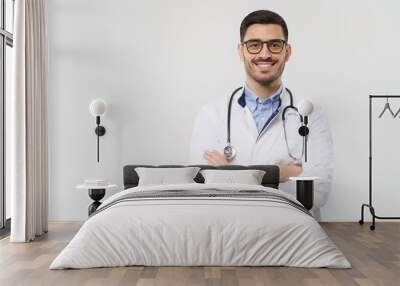 Horizontal banner of smiling young doctor ready to help patients with health problems, isolated on gray background with copy space on left Wall mural