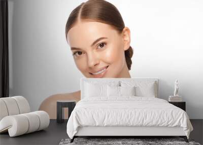 Portrait of young attractive smiling brown-eyed woman with naturally glowing skin Wall mural