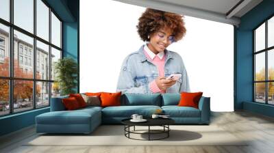 Smiling african american teenage girl with afro hairstyle, holding  phone with one hand, chatting with friend, using social media app, isolated Wall mural