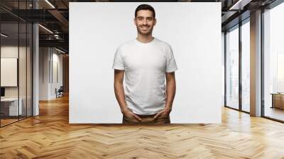 young european man standing with hands in pockets, wearing blank white tshirt with copy space for yo Wall mural