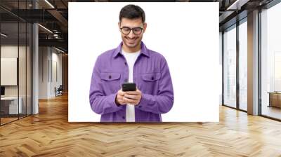 Young happy man looking at his phone Wall mural