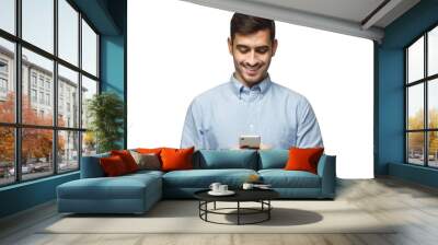 Young smiling business man in blue shirt reading sms, using smartphone, isolated on white background Wall mural