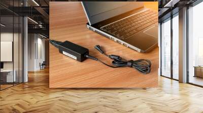 adapter power charger of laptop computer On a wooden table Wall mural