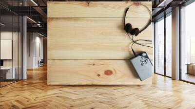 Old portable cassette tape player and headphones on wooden floor Wall mural