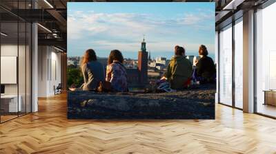 A group enjoying the view of a city.  Wall mural