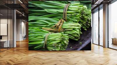 Bundles of the Chinese Vegetable Jiu Cai or commonly known as Garlic Chives for sale in a market in Zhaodong China. Wall mural